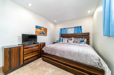 a bedroom with a bed and a flat screen tv at Pool Home in Hollywood