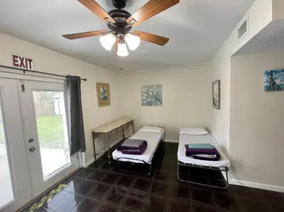 a room with two beds and a ceiling fan at Pool Home in Hollywood