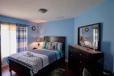 a bedroom with a bed and a dresser with a mirror at Fabulous Hollywood Living Space in Hollywood