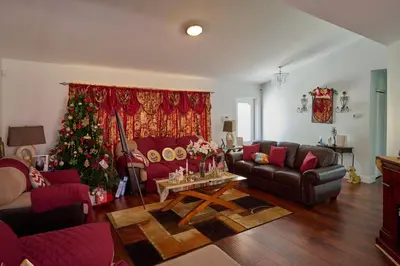 a living room with a christmas tree in the corner at Fabulous Hollywood Living Space in Hollywood