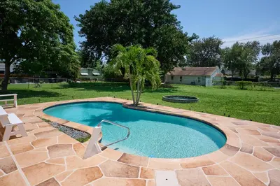 a small swimming pool with a palm tree in a yard at Fabulous Hollywood Living Space in Hollywood