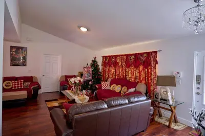 a living room with a couch and a christmas tree at Fabulous Hollywood Living Space in Hollywood