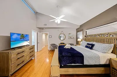 a bedroom with a large bed and a flat screen tv at Large home wking bed by PMI unit BH in Fort Lauderdale