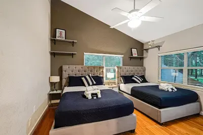 a bedroom with two beds and a ceiling fan at Large home wking bed by PMI unit BH in Fort Lauderdale