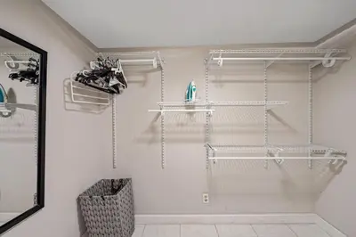 a bathroom with white shelves on the wall at Large home wking bed by PMI unit BH in Fort Lauderdale