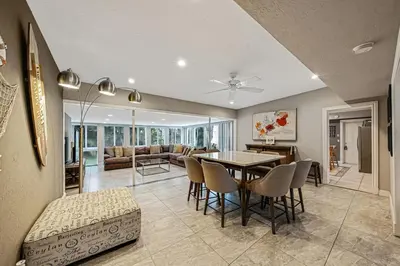 a dining room and living room with a table and chairs at Large home wking bed by PMI unit BH in Fort Lauderdale