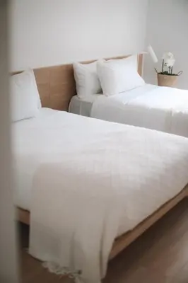 two beds sitting next to each other in a room at Beach Haus Bal Harbour in Miami Beach