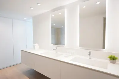 a white bathroom with two sinks and mirrors at Beach Haus Bal Harbour in Miami Beach