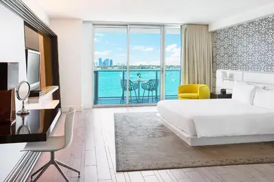 a bedroom with a bed and a view of the ocean at Mondrian South Beach in Miami Beach