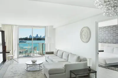 a white living room with a couch and a table at Mondrian South Beach in Miami Beach