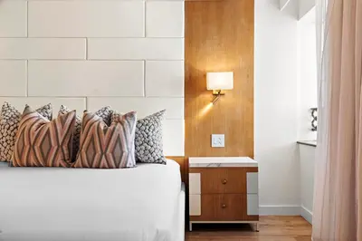 a bedroom with a bed and a nightstand with a lamp at Hotel Ocean in Miami Beach