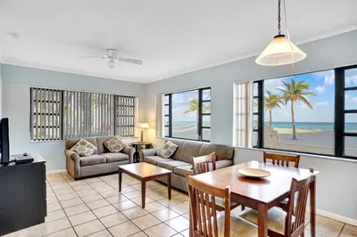 a living room with a couch and a table at Neptune Oceanfront Rentals in Hollywood