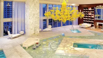 a living room with a chandelier and a pool at ICONIC LUXURIOUS HIGH CEILINGS UNIT BRICKELL w in Miami