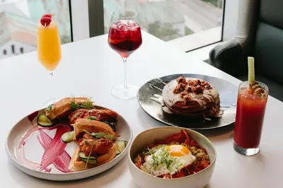a table with plates of food and a glass of juice at Majestic High Rise Unit with Ocean view in Miami