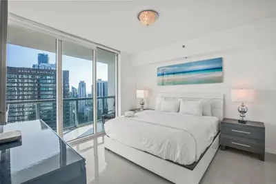 a white bedroom with a large bed and large windows at Splendid Unit outstanding View-W Hotel Brickell in Miami
