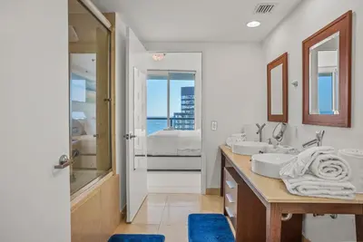 a white bathroom with two sinks and a shower at Splendid Unit outstanding View-W Hotel Brickell in Miami