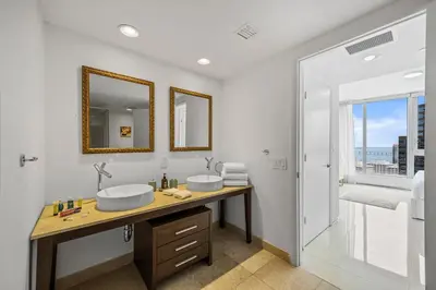 a bathroom with two sinks and a large window at Breathtaking Ocean View Unit Icon Brickell W in Miami