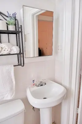 a white bathroom with a sink and a mirror at Little Havana Executive 11 in Miami