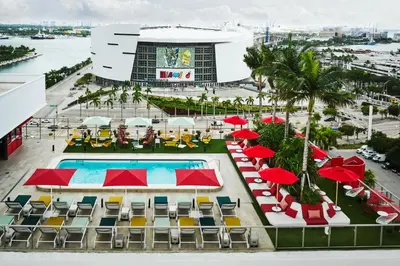 an aerial view of a resort with a pool and chairs and umbrellas at citizenM Miami World Center in Miami