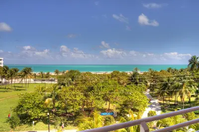 a view of the beach from the balcony of a resort at Dream Destinations at Ocean Place in Miami Beach