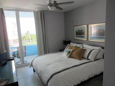 a bedroom with a bed and a window with a view at Dream Destinations at Ocean Place in Miami Beach