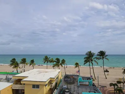 a view of a beach with palm trees and buildings at Tropic Isle Hotel & Apartment in Hollywood
