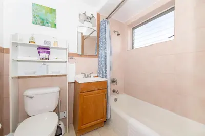a bathroom with a toilet and a tub and a sink at Tropic Isle Hotel & Apartment in Hollywood