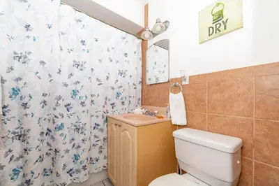 a bathroom with a toilet and a sink at Tropic Isle Hotel & Apartment in Hollywood