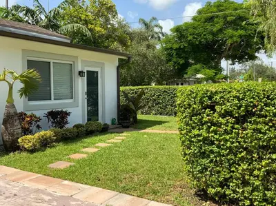 a yard with a house and a hedge at Taste of Miami Vive in Miami