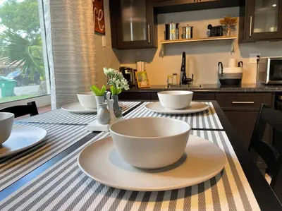 a table with bowls and plates on top of it at Taste of Miami Vive in Miami
