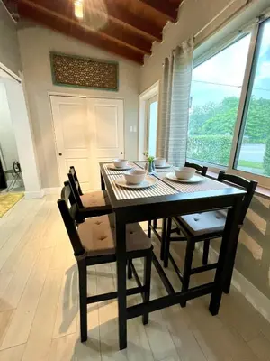 a dining room with a black table and chairs at Taste of Miami Vive in Miami