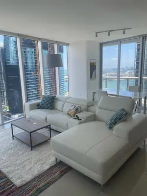 a living room with a white couch and large windows at IconBrickell Tower 3 W Residences in Miami