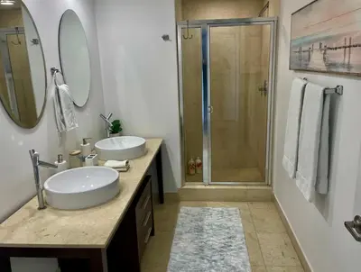 a bathroom with two sinks and a shower at IconBrickell Tower 3 W Residences in Miami