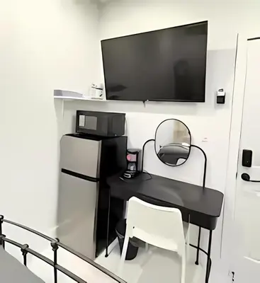 a black table with two chairs and a television on a wall at Gorgeous Private Room, near the Airport - Free parking - 01 in Miami