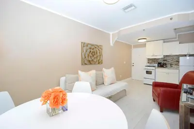 a living room with a white table and a couch at South of Fifth Ocean Drive Apt in Miami Beach
