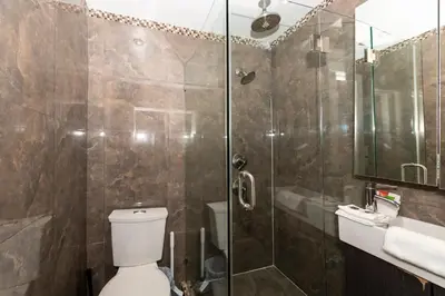 a bathroom with a shower and a toilet and a sink at South of Fifth Ocean Drive Apt in Miami Beach