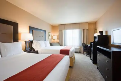 a hotel room with two beds and a flat screen tv at Holiday Inn Express Fort Lauderdale Airport South by IHG in Dania Beach