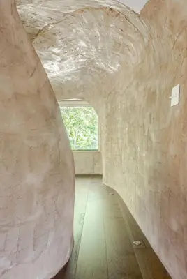 a room with a large stone wall and a window at Casa Ishi - at lumicollection in Miami