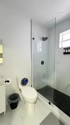 a white bathroom with a toilet and a shower at Cozy Private Room, near the Airport - Free parking - 01 in Miami