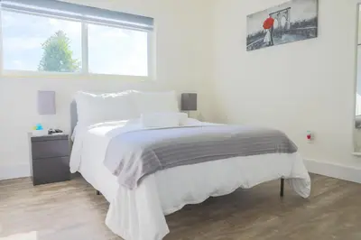 a white bedroom with a white bed and a window at MIAMI PARADISE in Miami