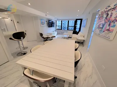 a room with a long table and chairs in it at Deluxe Beach Resort - HORA RENTALS in Miami Beach