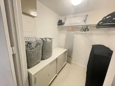 a room with white walls and shelves and a room with a room at Sun&Sea IconBrickell Unit in Miami