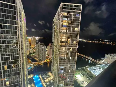 a view of a tall building in a city at night at Sun&Sea IconBrickell Unit in Miami