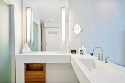 a white bathroom with a sink and a mirror at W Residences 2 Bedroom Suite condo in Fort Lauderdale