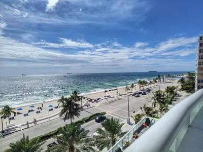 a view of a beach with palm trees and the ocean at W Residences 2 Bedroom Suite condo in Fort Lauderdale