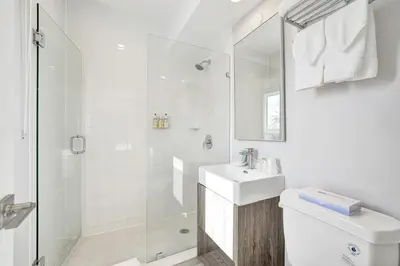 a white bathroom with a sink and a shower at Hotel Sheldon in Hollywood
