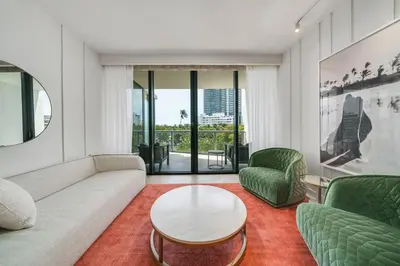 a living room with a couch and a table and chairs at W SOUTH BEACH Residences Private King Studio in Miami Beach