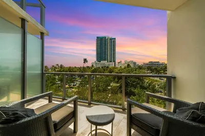 a balcony with chairs and a view of a city at W SOUTH BEACH Residences Private King Studio in Miami Beach