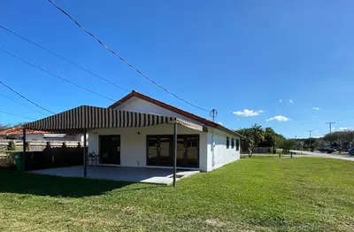 a building with an awning next to a grass field at LYZ Miami in Miami