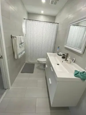 a white bathroom with a sink and a toilet at LYZ Miami in Miami